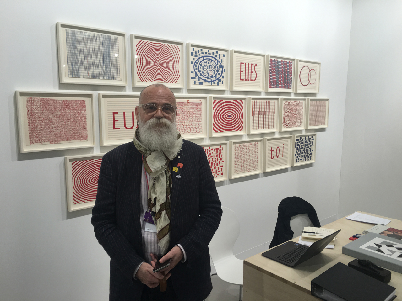 AA Bronson captured in Caroline Nitsch's booth at Art Basel in front of works by Louise Bourgeois, Art Basel, 2016. © FAM Editorial