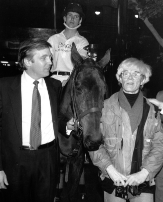 Donald Trump owner of New York’s Trump Tower, holds the bridle of a polo pony while talking to Andy Warhol. Image: Mario Suriani