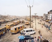 Danfos and Moules (private bus-taxi) at the Badagry Road expansion projekt at the Odun Ade bus stop, Lagos, Nigeria
